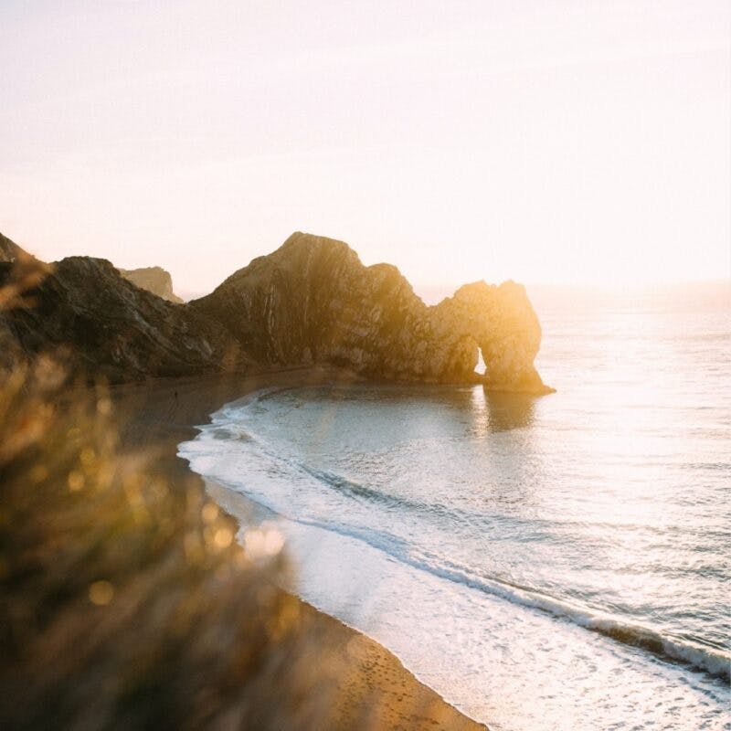 Sunset behind the unique arch on the Dorset coast
