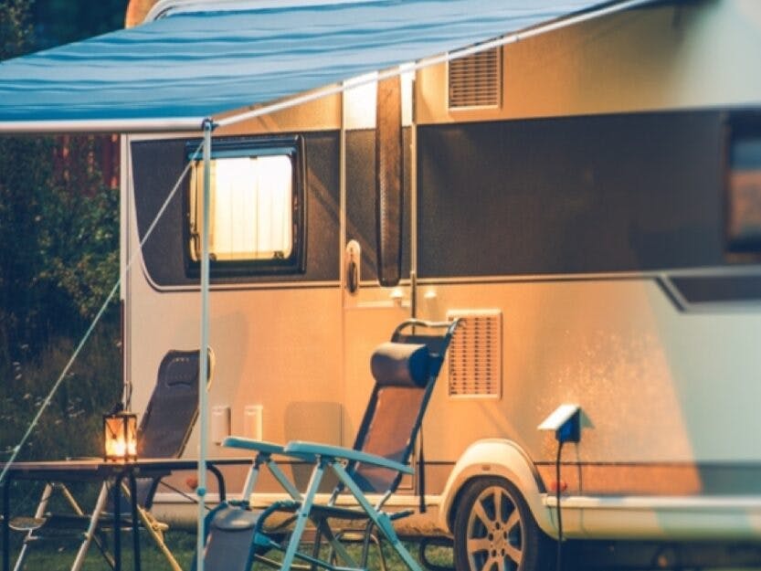 Caravan with awning extended in early evening